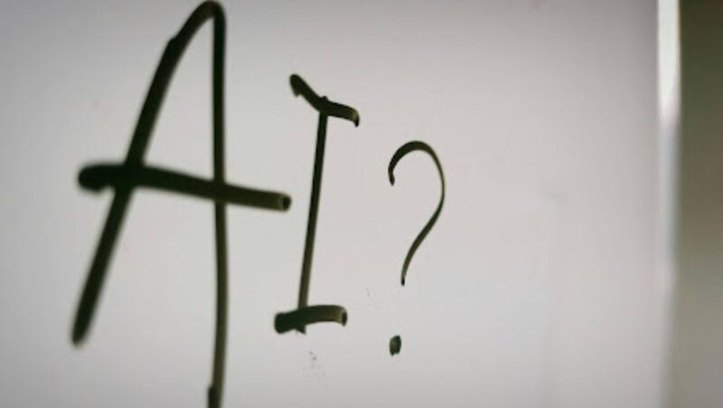 “AI” and a question mark written on a white board